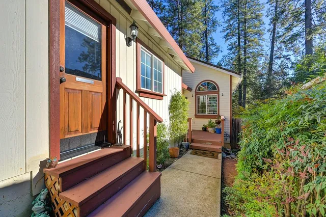 a living room with patio furniture and a chandelier