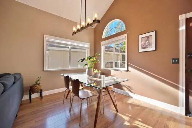 a living room with furniture a flat screen tv and a large window