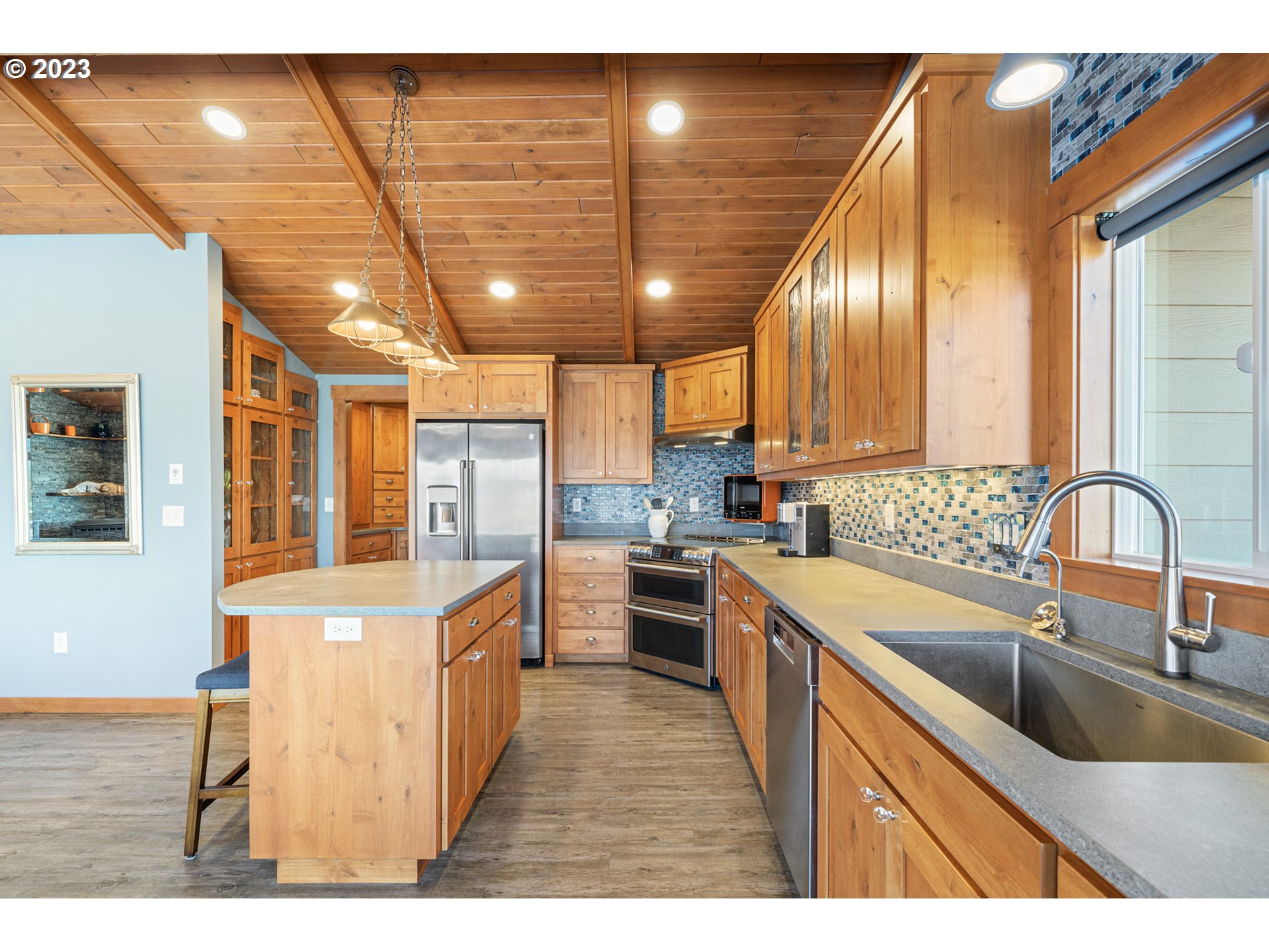 5430 2nd Street Northwest Tillamook, OR 97141 - Photo 11 of 48 a kitchen with stainless steel appliances granite countertop a sink and wooden cabinets