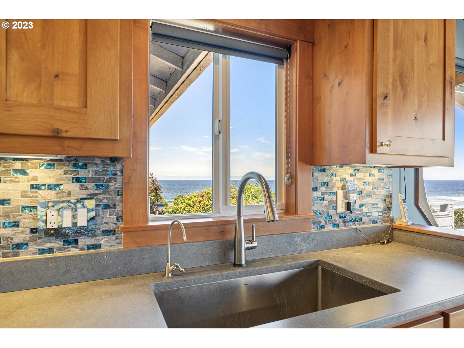 5430 2nd Street Northwest Tillamook, OR 97141 - Photo 12 of 48 a kitchen with kitchen island a sink a stove and a window