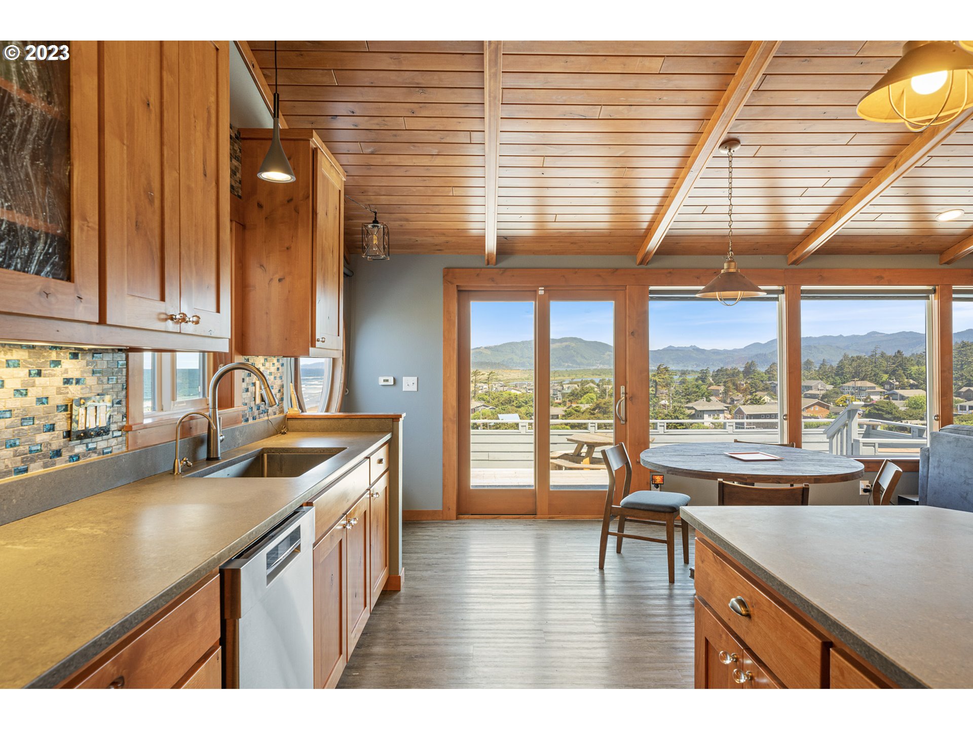 5430 2nd Street Northwest Tillamook, OR 97141 - Photo 13 of 48 a kitchen that has a sink and a wooden floor