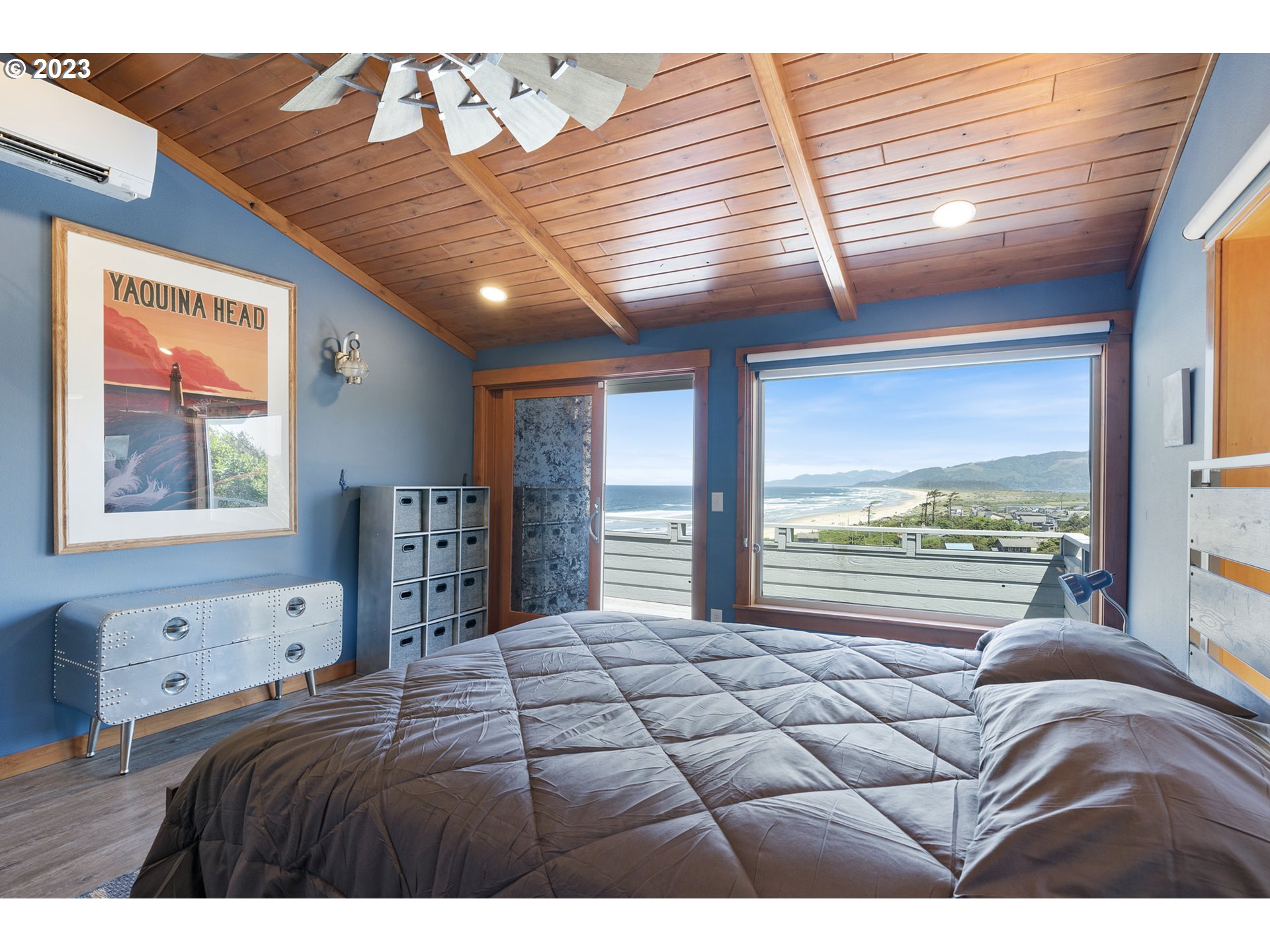 5430 2nd Street Northwest Tillamook, OR 97141 - Photo 19 of 48 a bedroom with a large bed and a large window