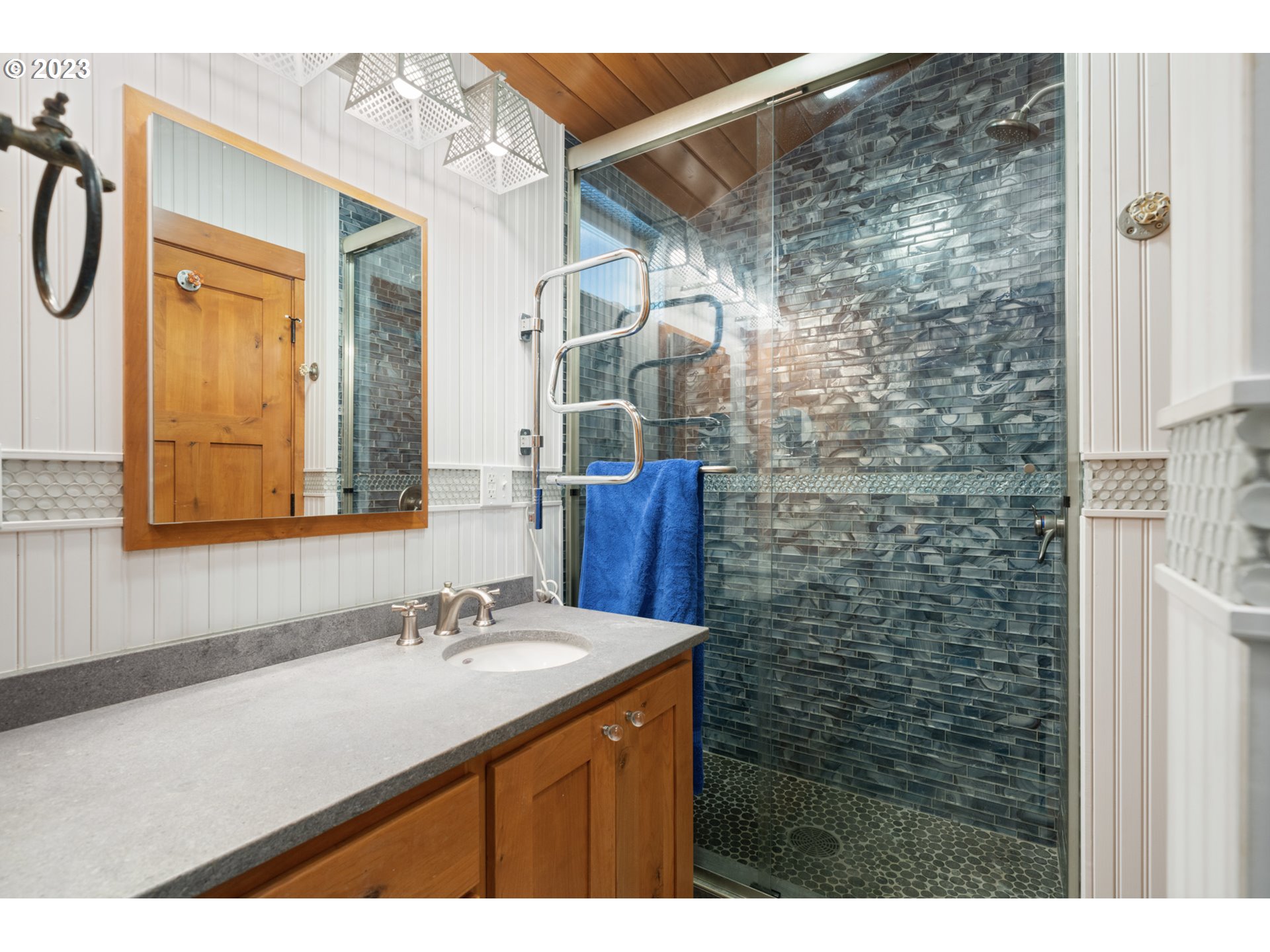 5430 2nd Street Northwest Tillamook, OR 97141 - Photo 24 of 48 a bathroom with a shower sink and mirror