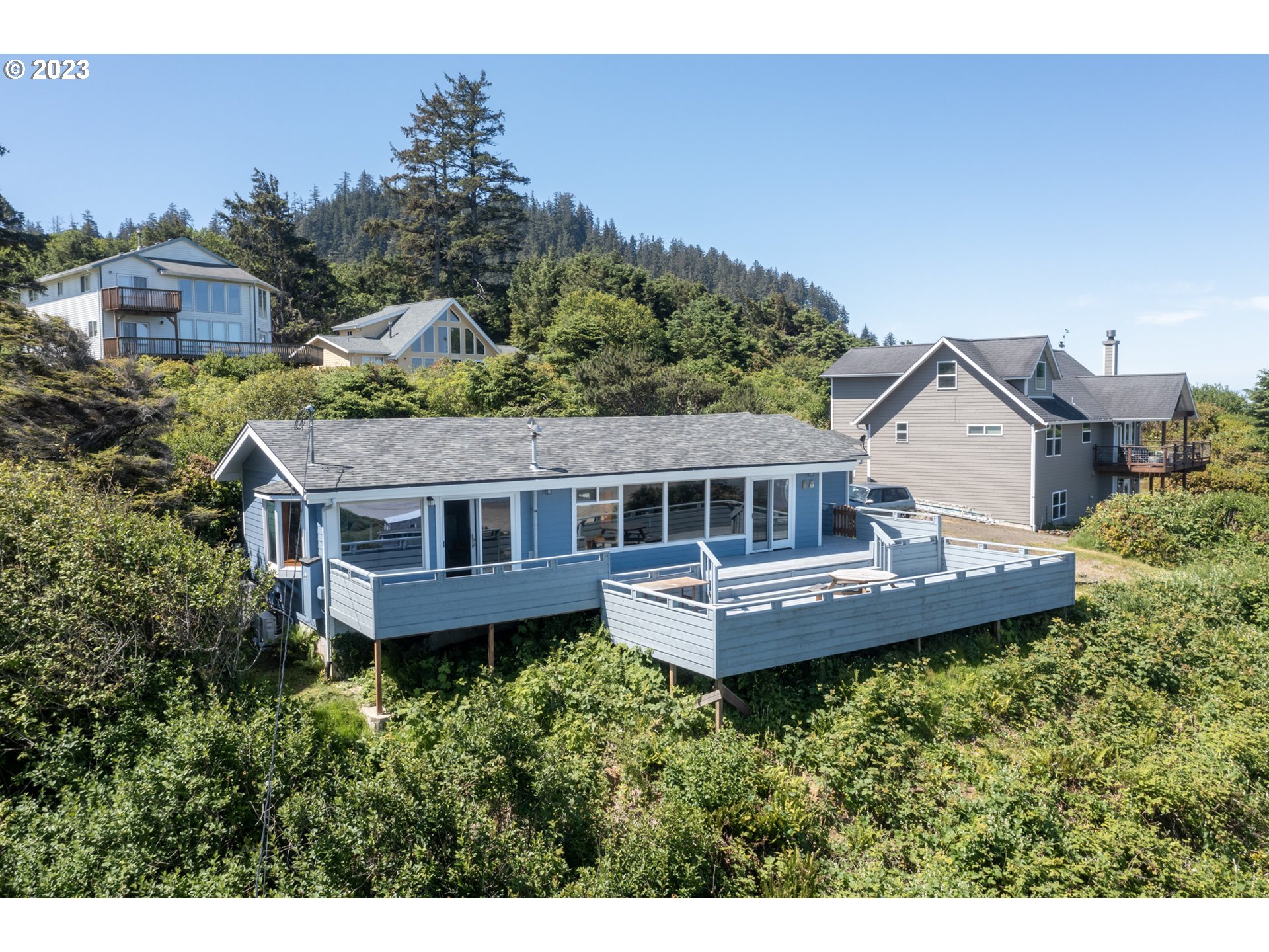 5430 2nd Street Northwest Tillamook, OR 97141 - Photo 38 of 48 a view of a house with a garden and deck