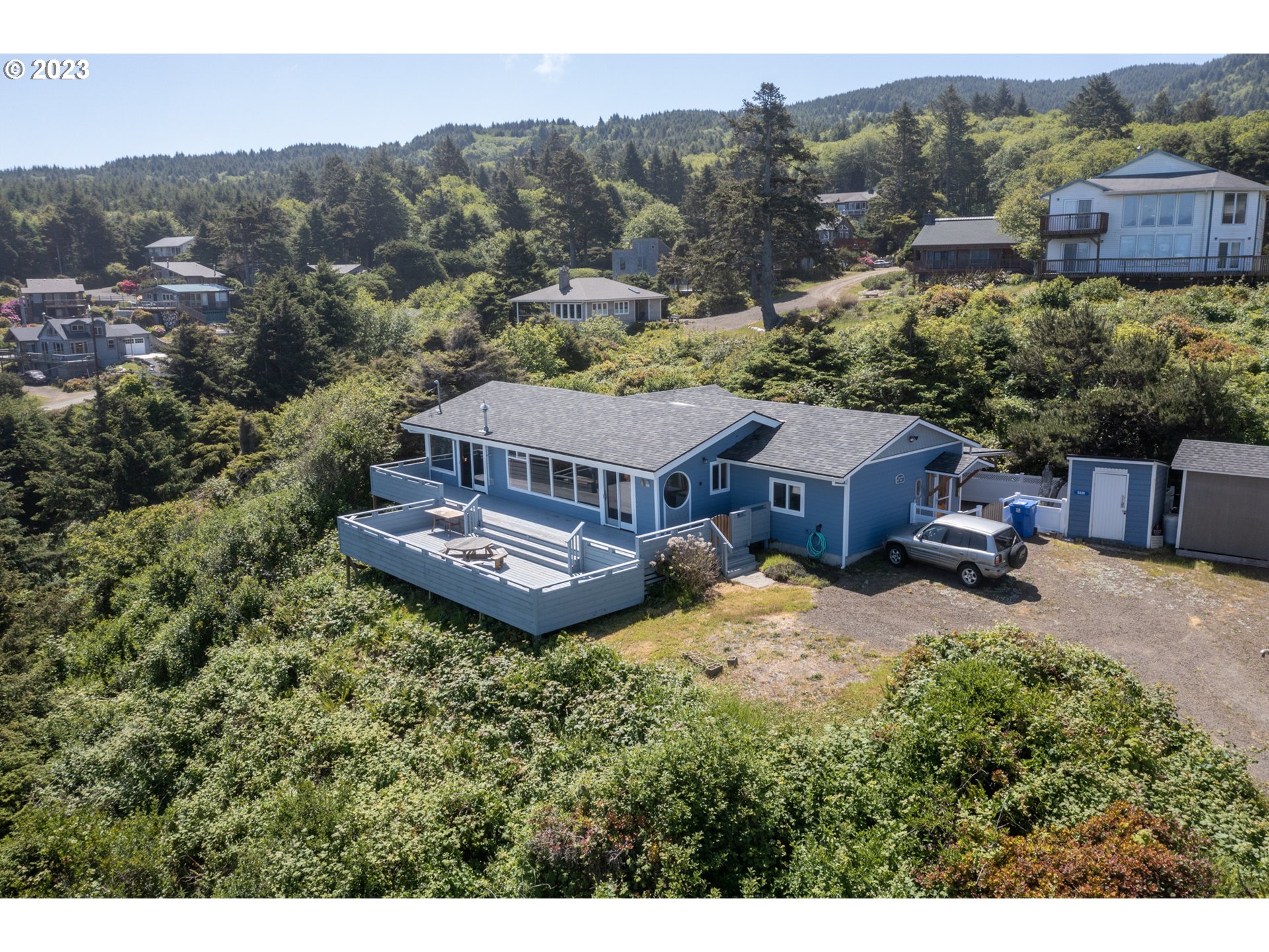 5430 2nd Street Northwest Tillamook, OR 97141 - Photo 43 of 48 a view of a house with a garden and a mountain