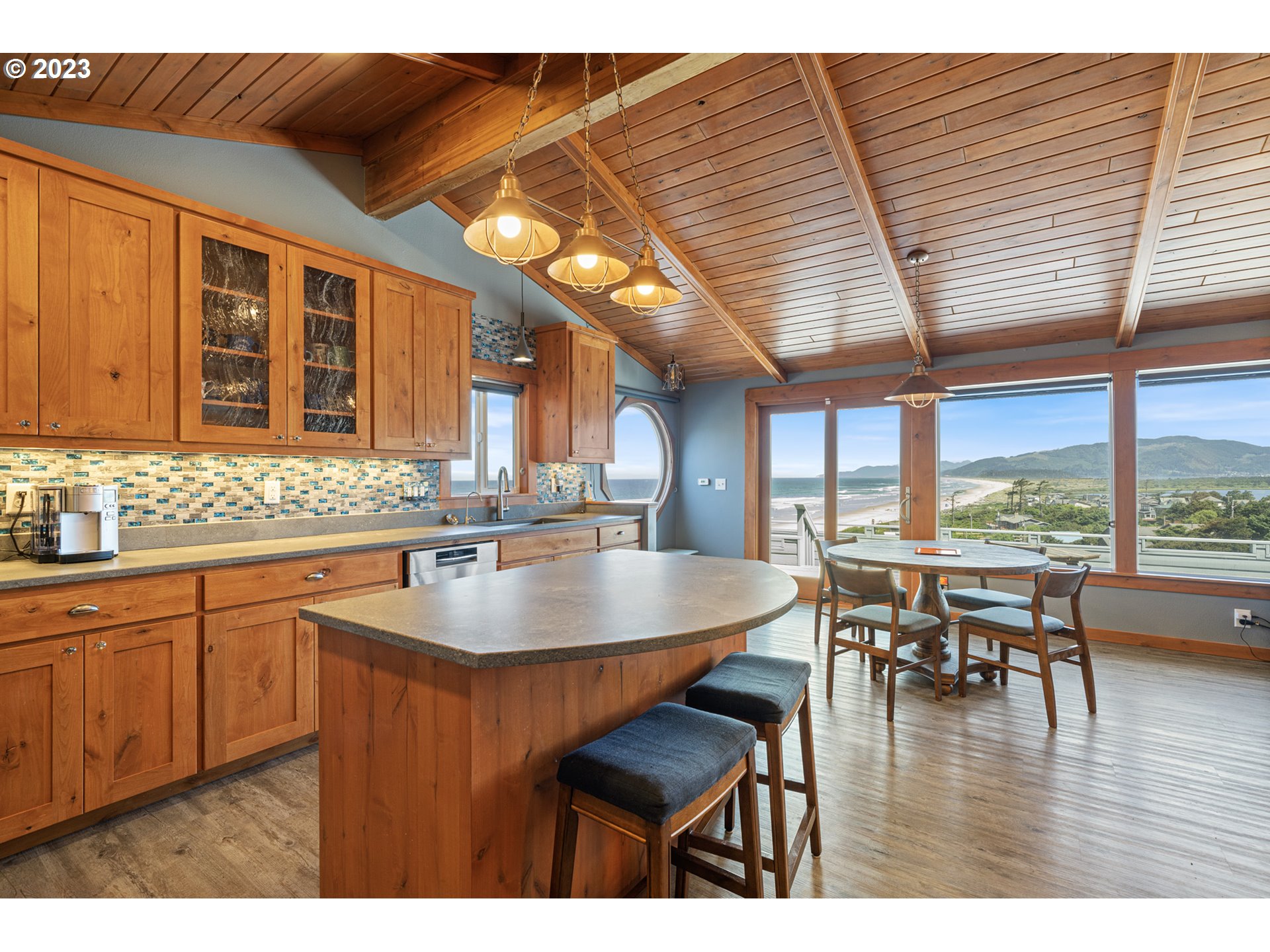 5430 2nd Street Northwest Tillamook, OR 97141 - Photo 6 of 48 a kitchen with a table chairs and wooden floor