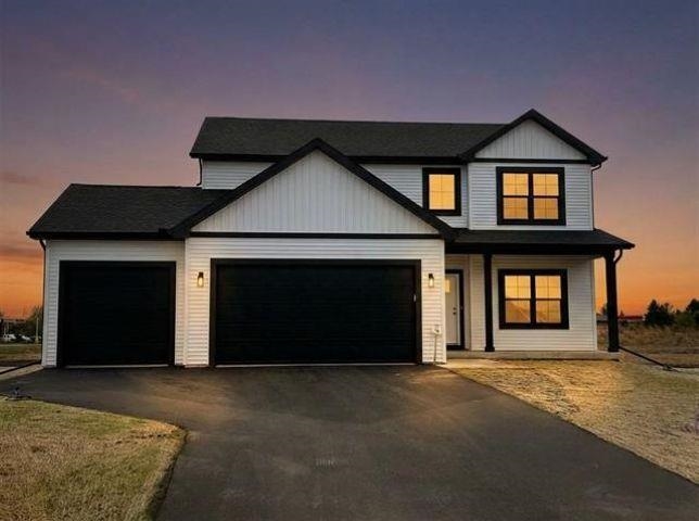 14192 Prairie Commons Lane South Beloit, IL 61080 - Photo 1 of 29 a front view of a house with a yard and garage