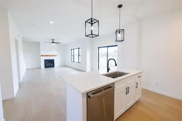 a kitchen with a sink and chandelier