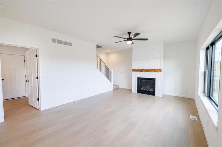 14192 Prairie Commons Lane South Beloit, IL 61080 - Photo 14 of 29 wooden floor fireplace and windows in an empty room