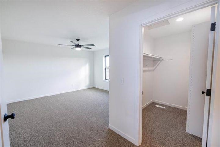 14192 Prairie Commons Lane South Beloit, IL 61080 - Photo 19 of 29 a view of a hallway with a ceiling fan