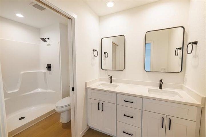 14192 Prairie Commons Lane South Beloit, IL 61080 - Photo 20 of 29 a bathroom with a double vanity sink mirror double and a bathtub