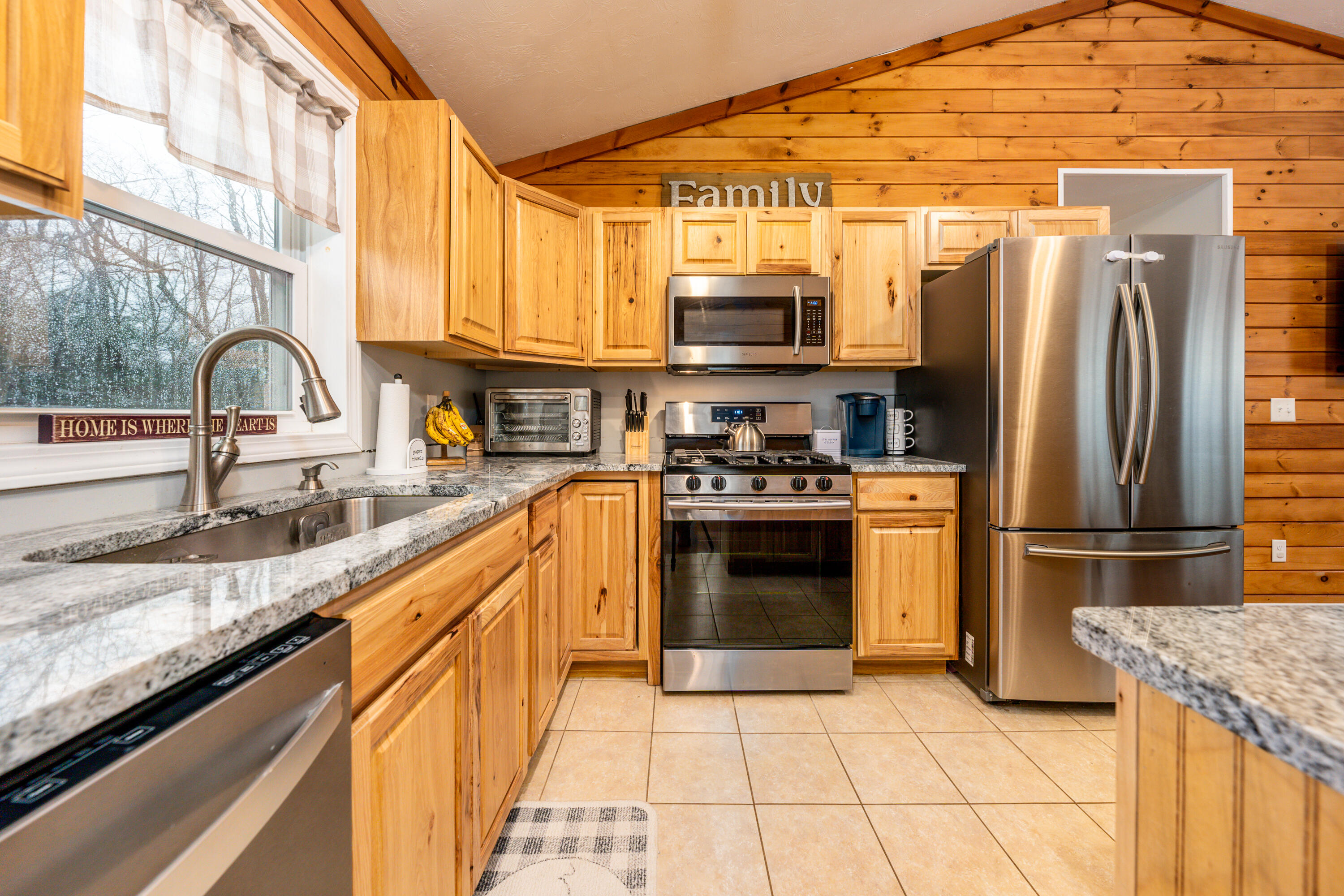 5 Tremont Center Road West Wareham, MA 02576 - Photo 6 of 17 a kitchen with stainless steel appliances granite countertop a refrigerator a stove and a sink with wooden cabinets