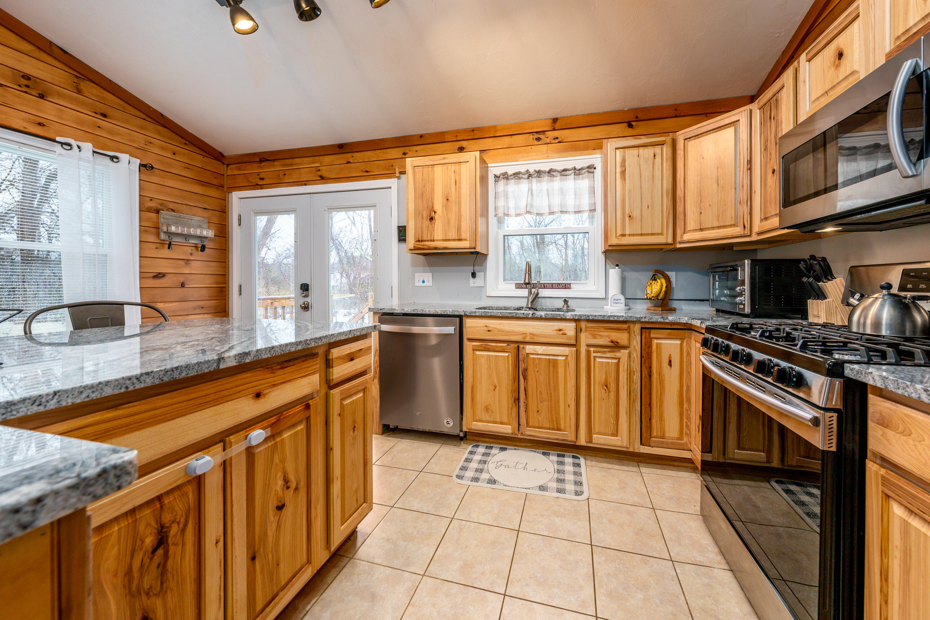 5 Tremont Center Road West Wareham, MA 02576 - Photo 7 of 17 a kitchen with stainless steel appliances granite countertop a stove a sink dishwasher and a microwave oven with cabinets