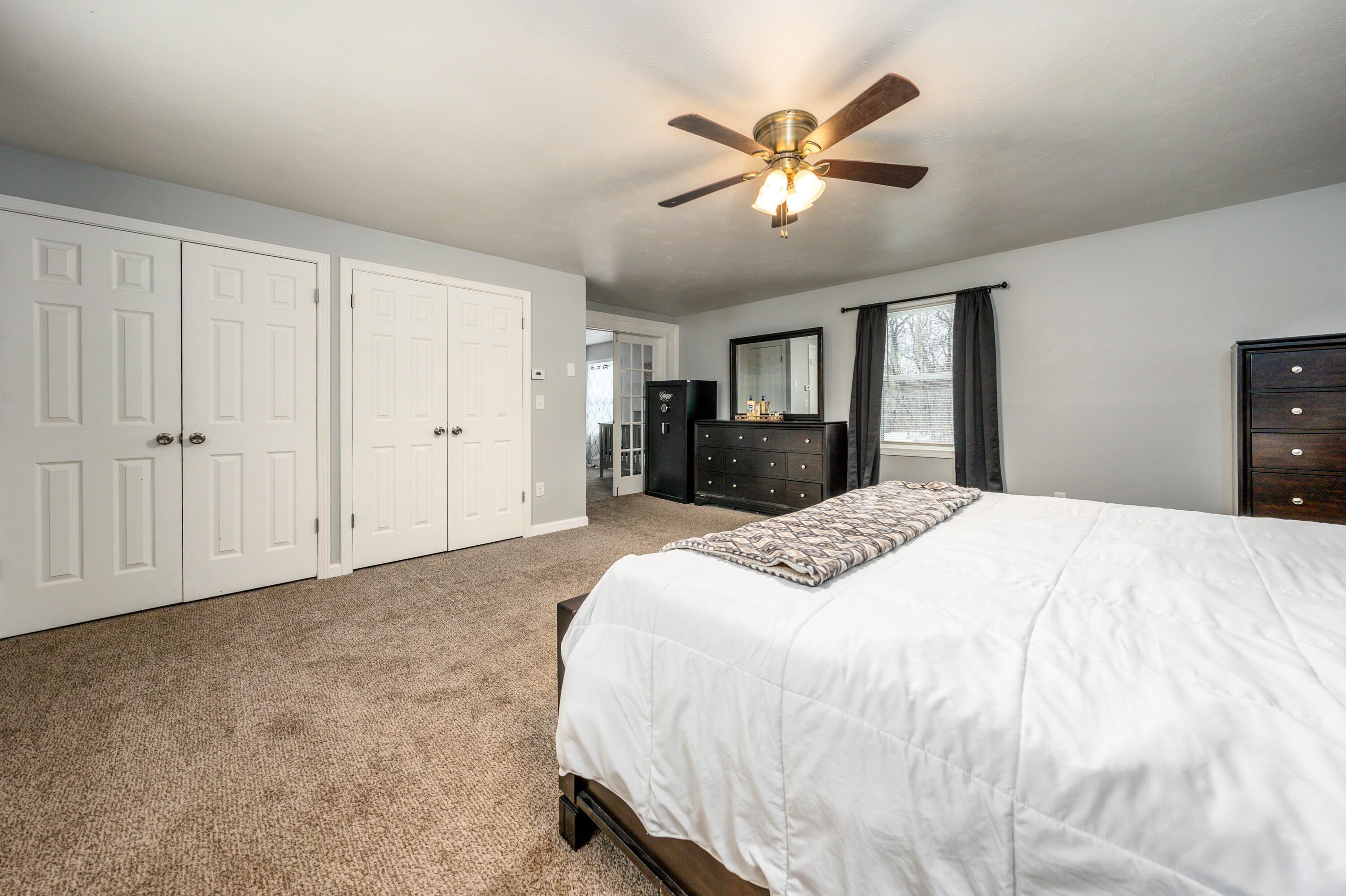 5 Tremont Center Road West Wareham, MA 02576 - Photo 10 of 17 a spacious bedroom with a large bed and a chandelier