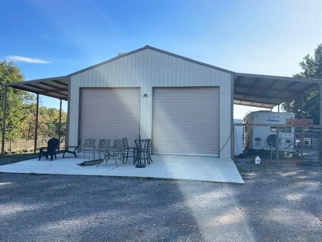 a backyard of a house with table and chairs