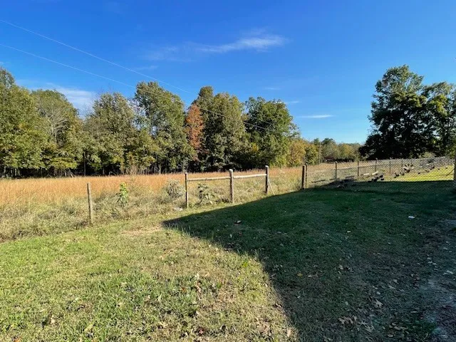 a view of a yard with a house in the background