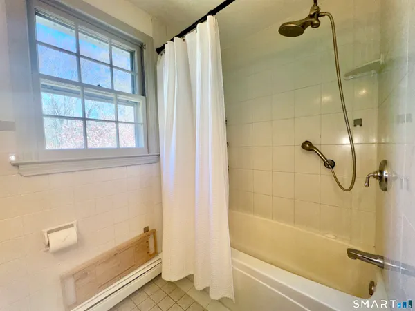 a bathroom with a shower and a bathtub