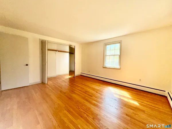 a view of an empty room and wooden floor
