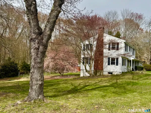 a front view of house with yard and trees