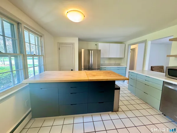 a kitchen with a sink cabinets and window