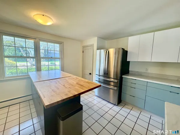 a kitchen with a sink refrigerator and microwave