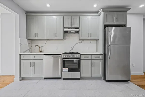 a kitchen with refrigerator a stove and cabinets