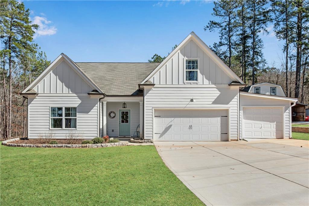 555 Masters Way Athens, GA 30607 - Photo 1 of 1 a view of a white house with a small yard and large tree