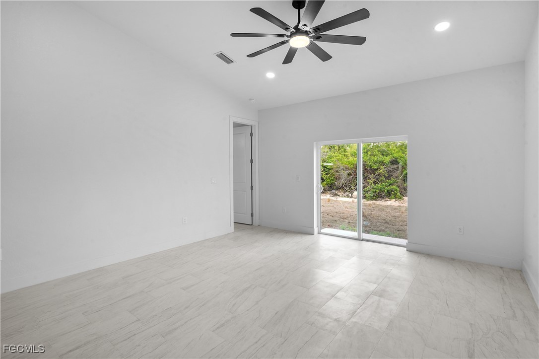 634 Knapp Street Lehigh Acres, FL 33974 - Photo 11 of 29 a view of a livingroom with a ceiling fan and window
