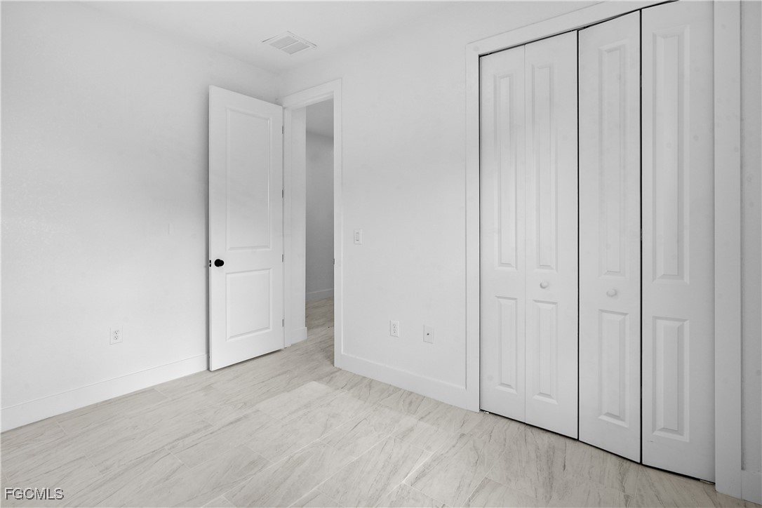 634 Knapp Street Lehigh Acres, FL 33974 - Photo 15 of 29 an empty room with wooden floor