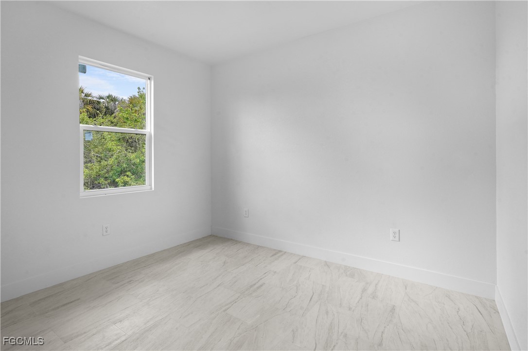 634 Knapp Street Lehigh Acres, FL 33974 - Photo 18 of 29 an empty room with a window