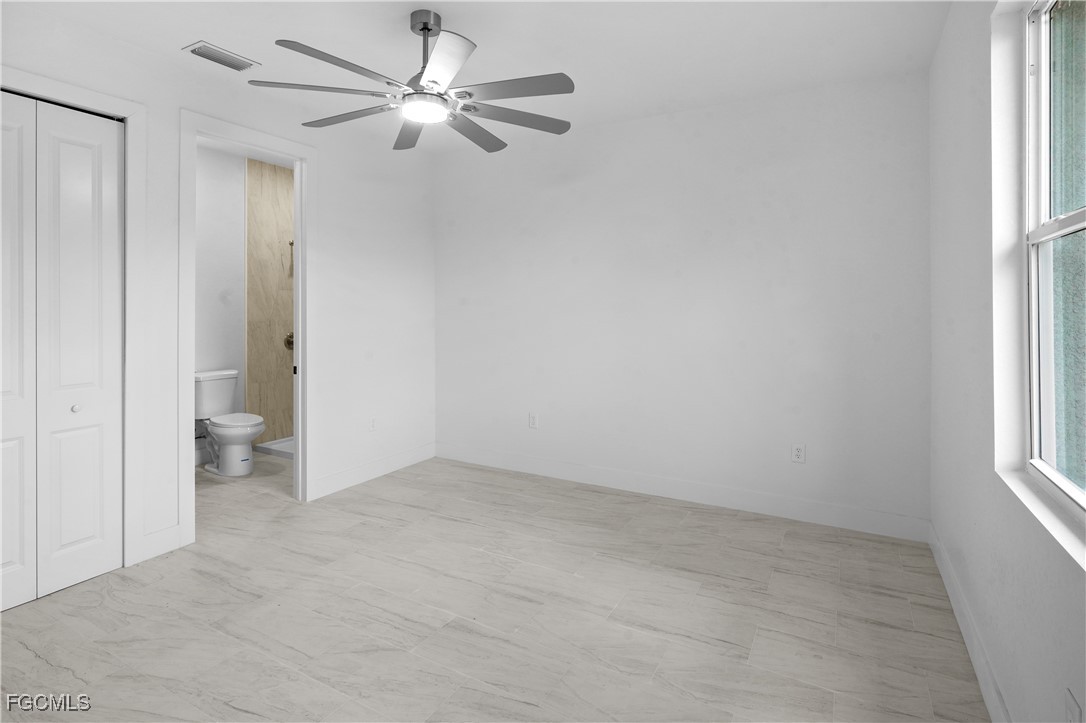 634 Knapp Street Lehigh Acres, FL 33974 - Photo 20 of 29 wooden floor in an empty room with a window