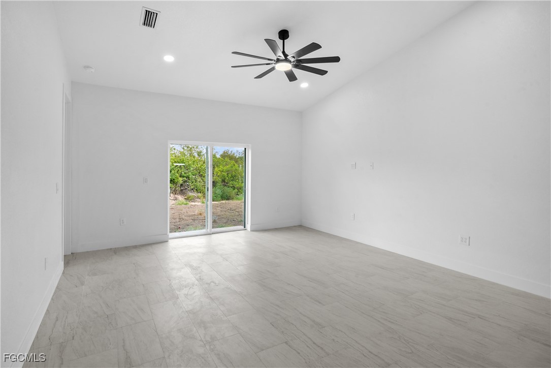 634 Knapp Street Lehigh Acres, FL 33974 - Photo 2 of 29 an empty room with fan and windows
