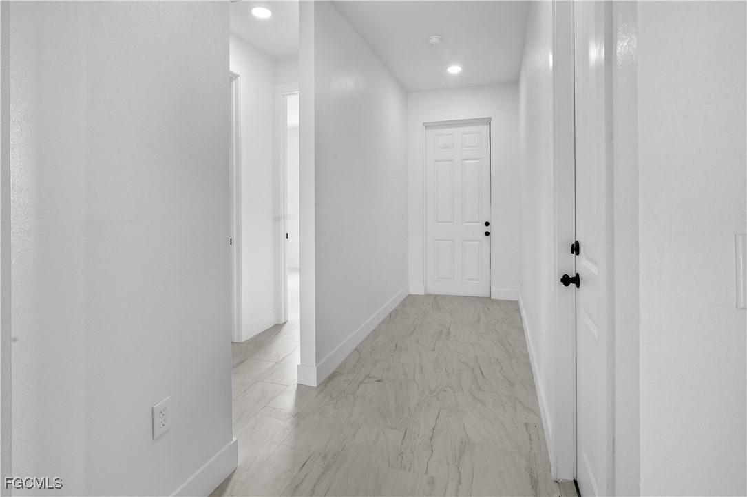 634 Knapp Street Lehigh Acres, FL 33974 - Photo 26 of 29 a view of a hallway with wooden floor