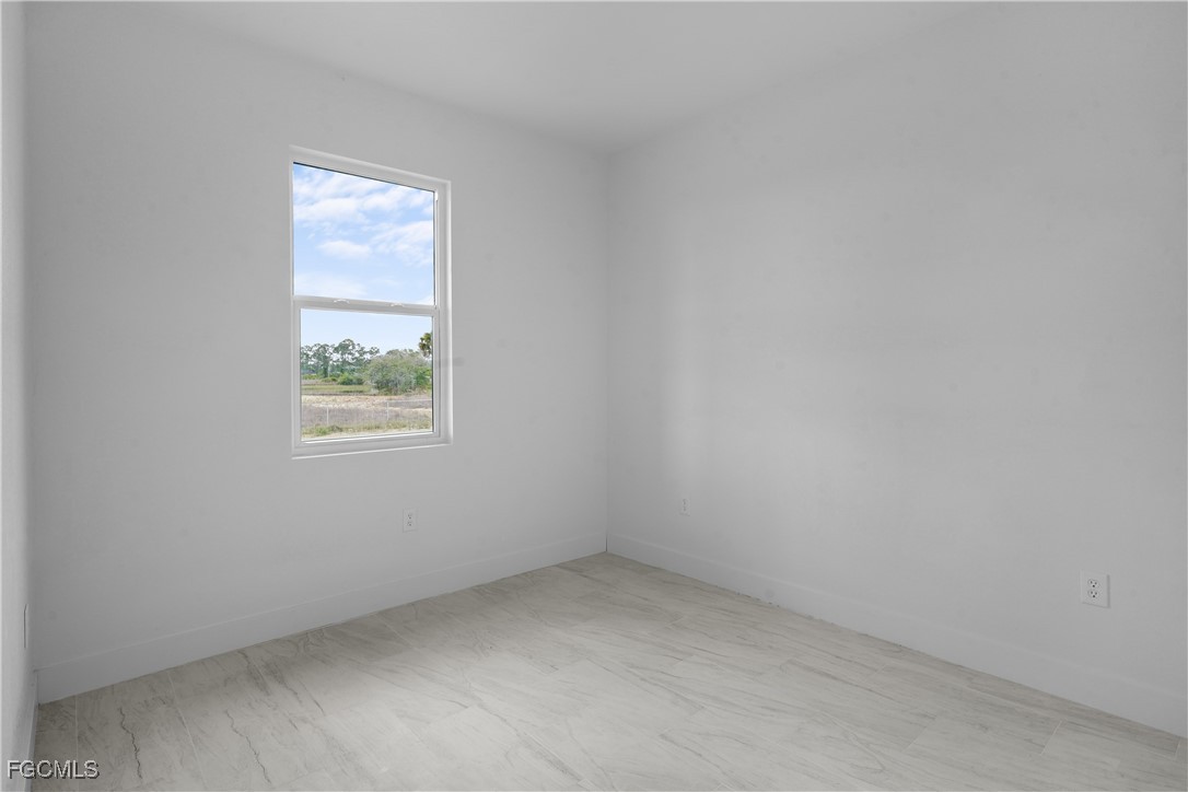 634 Knapp Street Lehigh Acres, FL 33974 - Photo 28 of 29 an empty room with a window