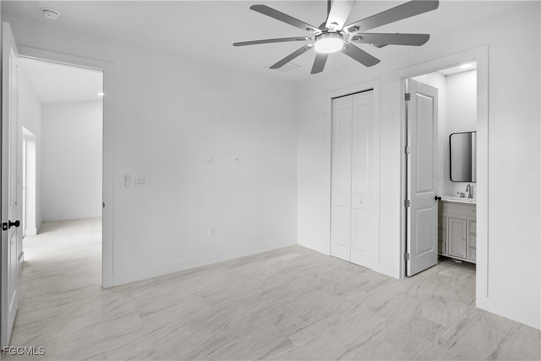 634 Knapp Street Lehigh Acres, FL 33974 - Photo 7 of 29 a view of a hallway with a chandelier fan