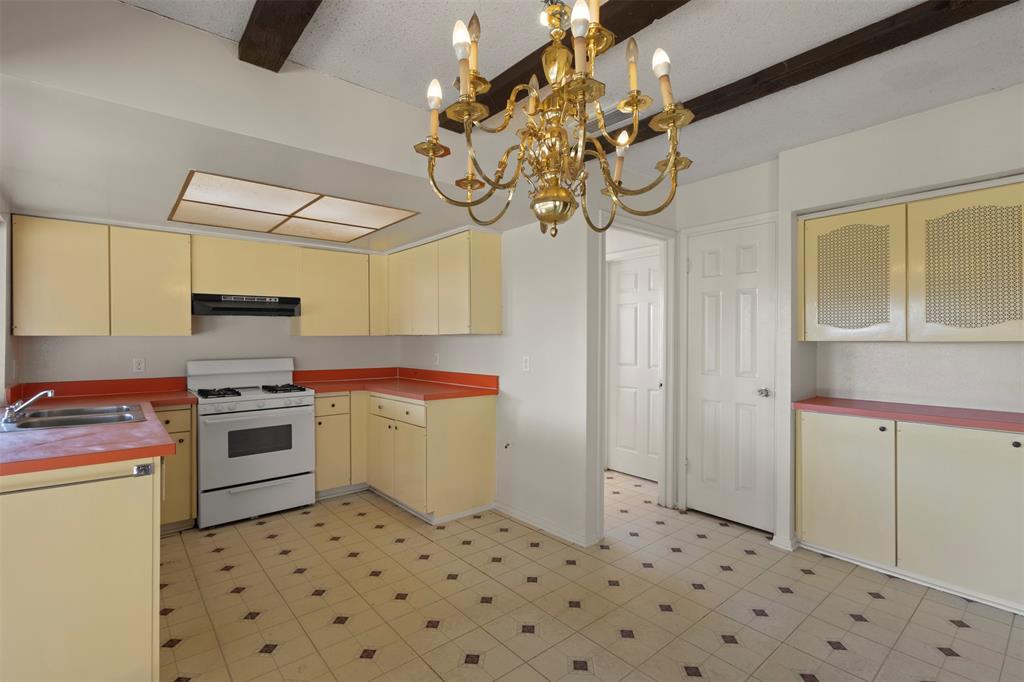 1400 Ridgecrest Drive Plano, TX 75074 - Photo 11 of 32 a kitchen with stainless steel appliances a stove a sink and a refrigerator