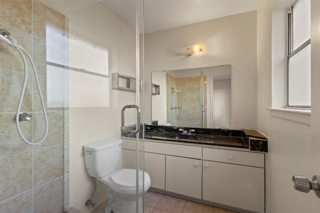 1400 Ridgecrest Drive Plano, TX 75074 - Photo 16 of 32 a bathroom with a granite countertop sink a toilet and a mirror