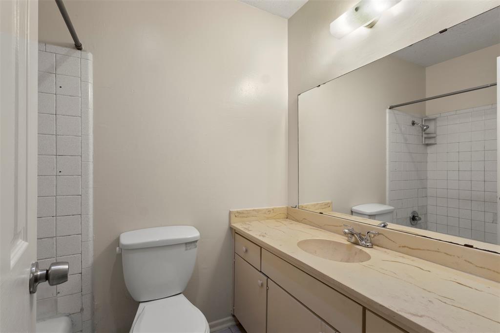 1400 Ridgecrest Drive Plano, TX 75074 - Photo 19 of 32 a bathroom with a toilet sink and mirror