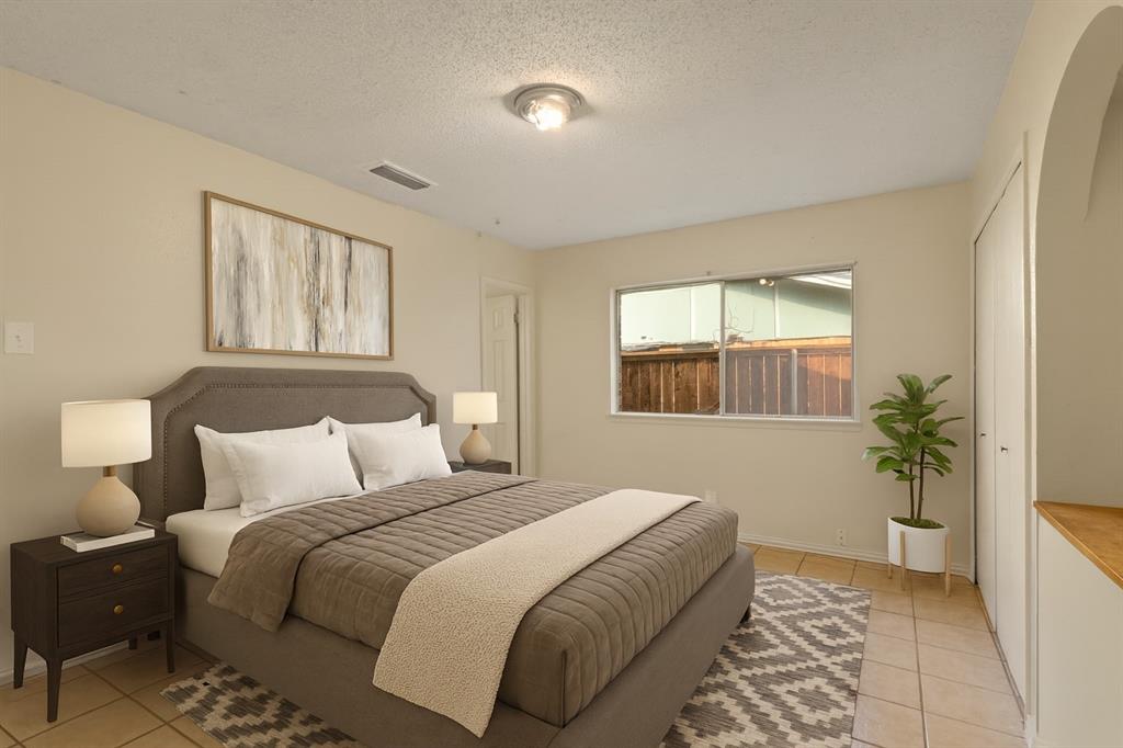 1400 Ridgecrest Drive Plano, TX 75074 - Photo 4 of 32 a bedroom with a bed and a potted plant