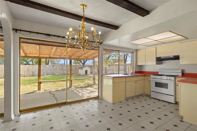 a kitchen with a stove a sink and a refrigerator