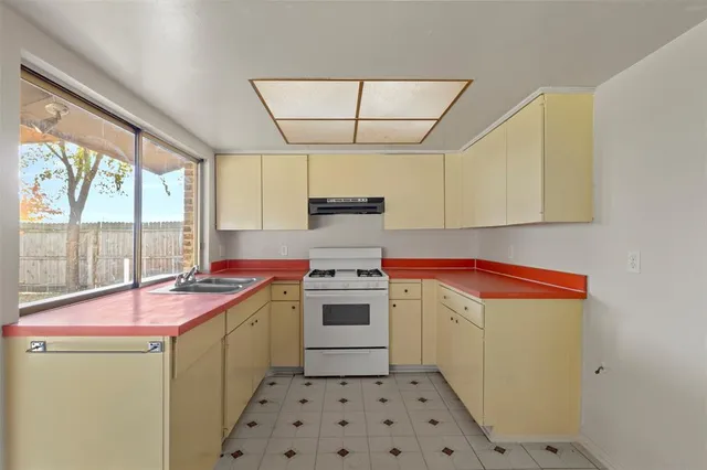a kitchen with a sink stove and cabinets