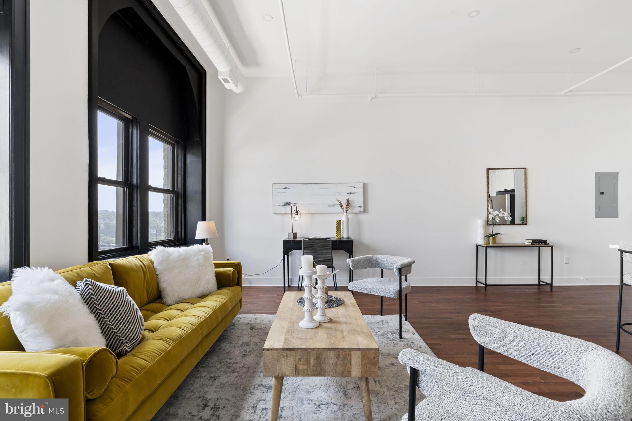 240 Hermitage Street, Unit 202 Philadelphia, PA 19127 - Photo 11 of 23 a living room with furniture and a large window
