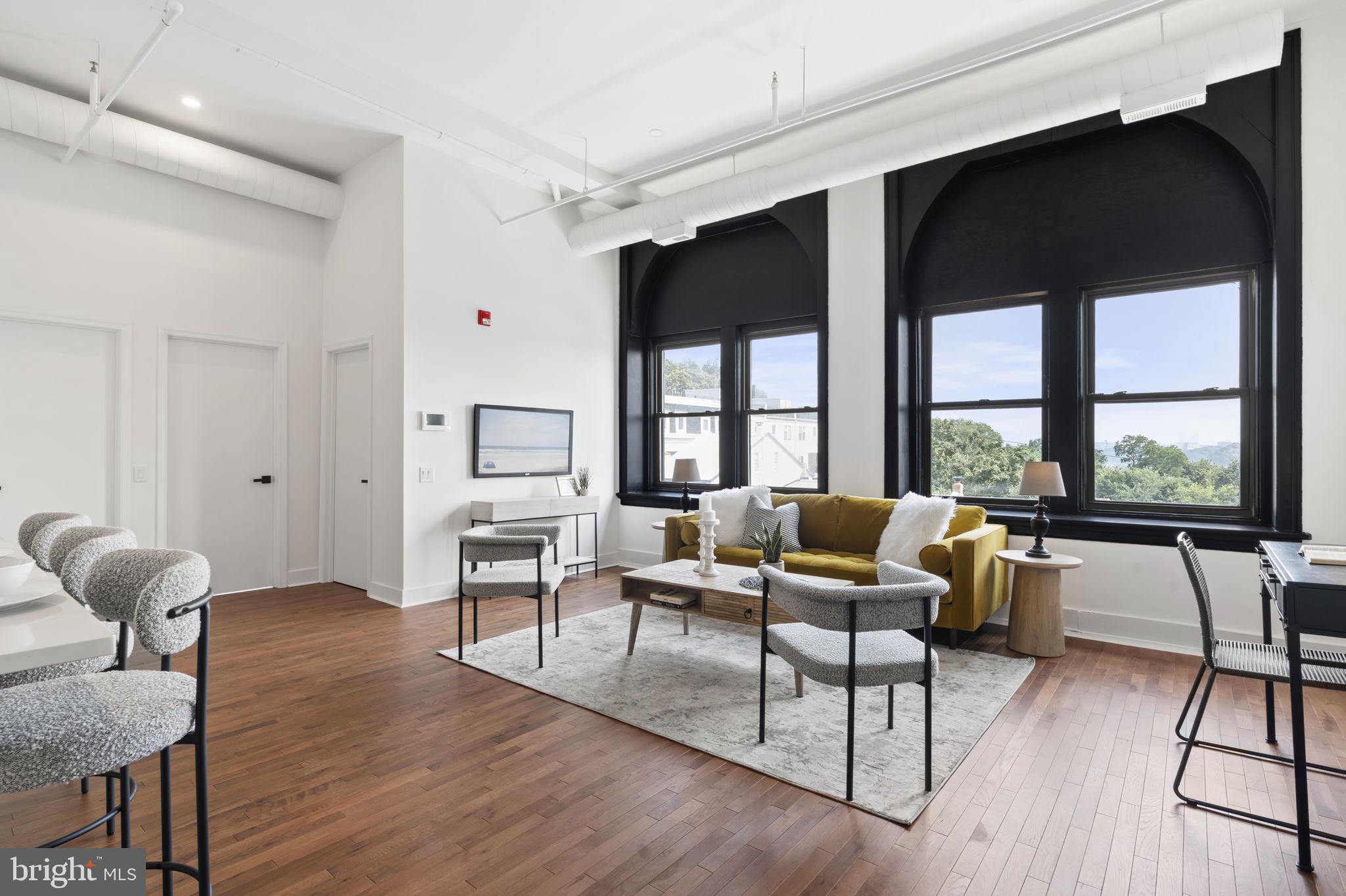 240 Hermitage Street, Unit 202 Philadelphia, PA 19127 - Photo 12 of 23 a living room with furniture and a large window
