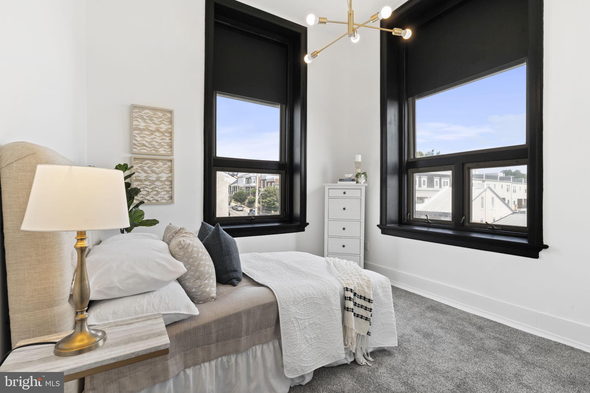 240 Hermitage Street, Unit 202 Philadelphia, PA 19127 - Photo 16 of 23 a bedroom with a bed and a painting on the wall