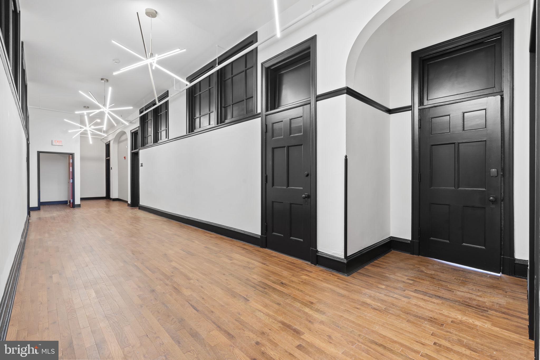 240 Hermitage Street, Unit 202 Philadelphia, PA 19127 - Photo 21 of 23 a view of a hallway with wooden floor and staircase