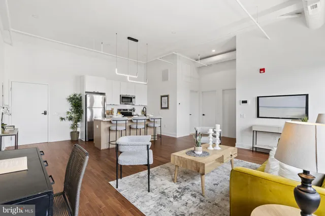 a living room with furniture kitchen view and a table
