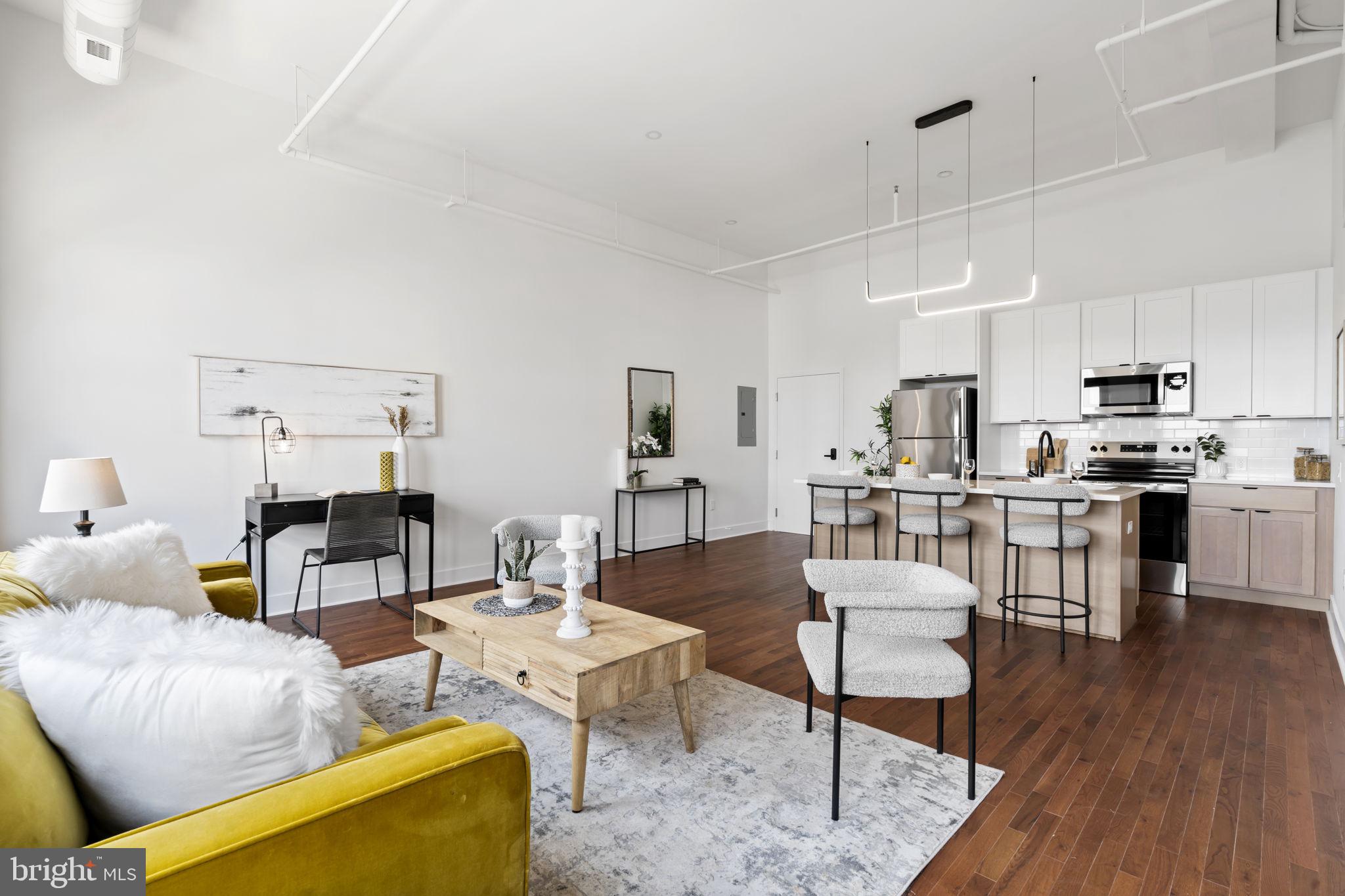 240 Hermitage Street, Unit 202 Philadelphia, PA 19127 - Photo 7 of 23 a living room with furniture kitchen view and a wooden floor