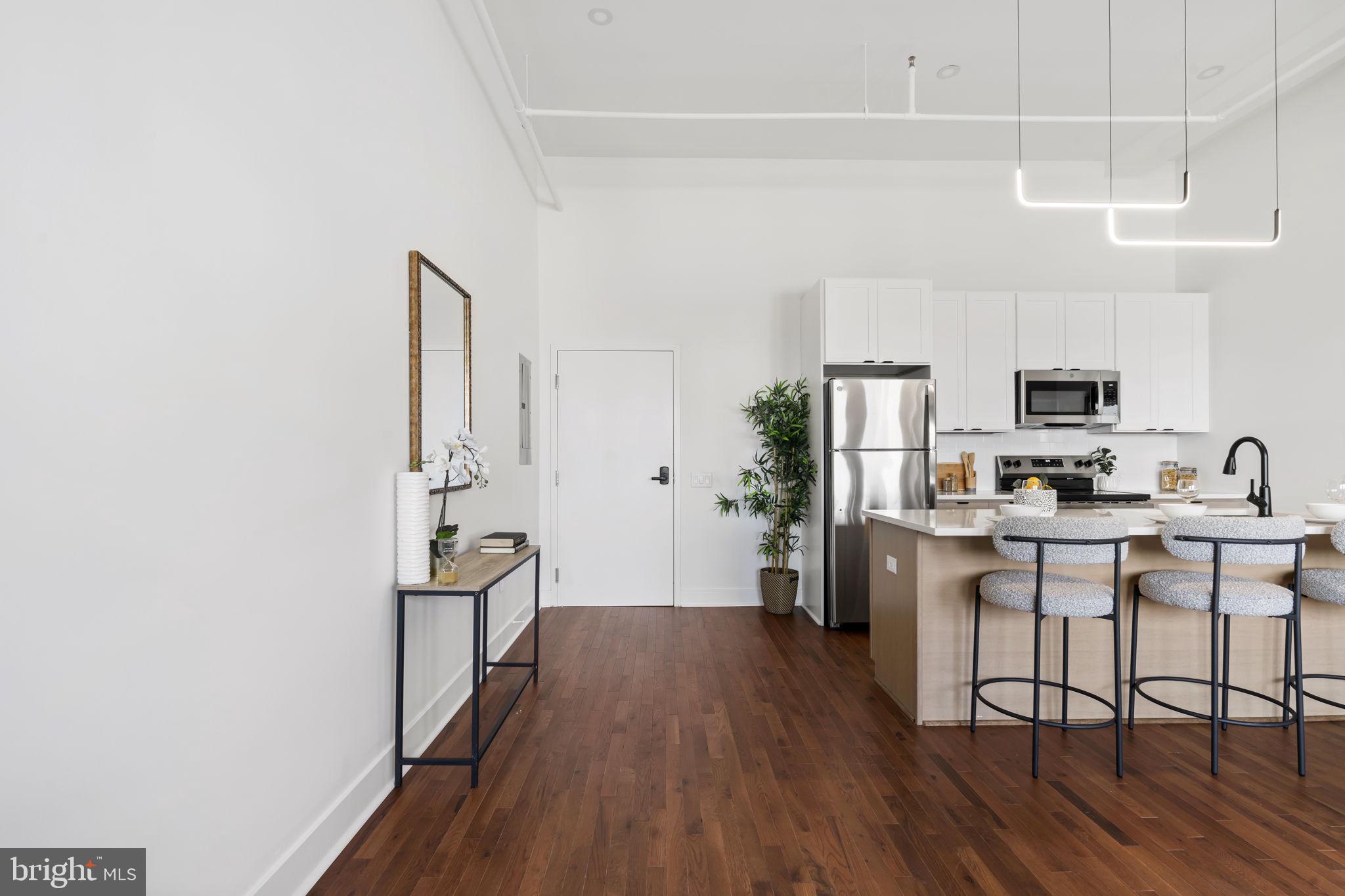240 Hermitage Street, Unit 202 Philadelphia, PA 19127 - Photo 8 of 23 a kitchen with stainless steel appliances a refrigerator and a stove top oven