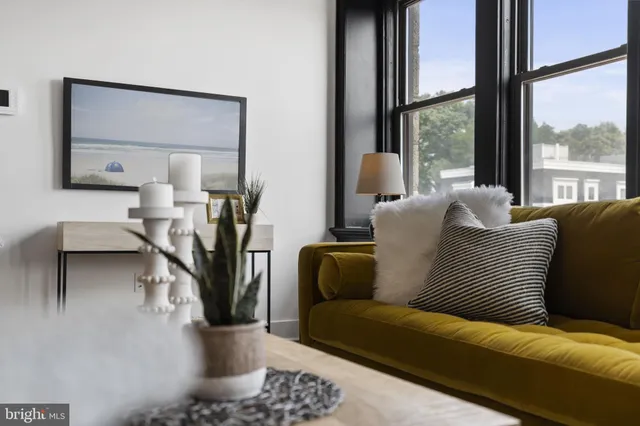 a living room with furniture and a large window