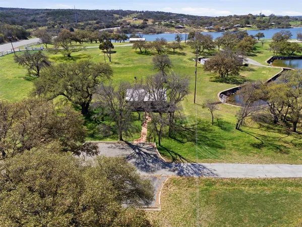 an aerial view of residential houses with outdoor space and swimming pool